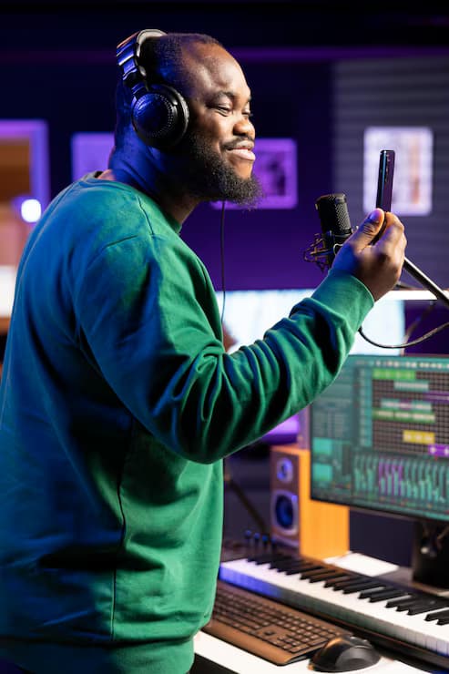 Young songwriter recording a new song at a studio microphone